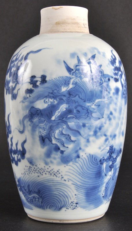 A MID 17TH CENTURY CHINESE BLUE AND WHITE JAR Tr: A MID 17TH CENTURY CHINESE BLUE AND WHITE JAR Transitional Period, painted with a dragon amongst crashing waves. Hairline from rim.6.75ins high.
