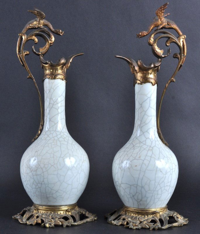 A PAIR OF 19TH CENTURY CHINESE WHITE GLAZED VASE: A PAIR OF 19TH CENTURY CHINESE WHITE GLAZED VASES with 19th century Ormolu mounts forming ewers, of scrolling rococo form. Good condition.14.5ins high.