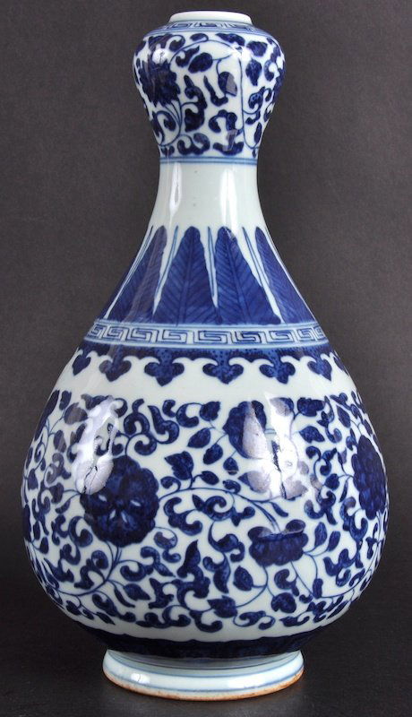 A CHINESE BLUE AND WHITE BULBOUS VASE painted with: A CHINESE BLUE AND WHITE BULBOUS VASE painted with foliage. Good condition.10.25ins high.