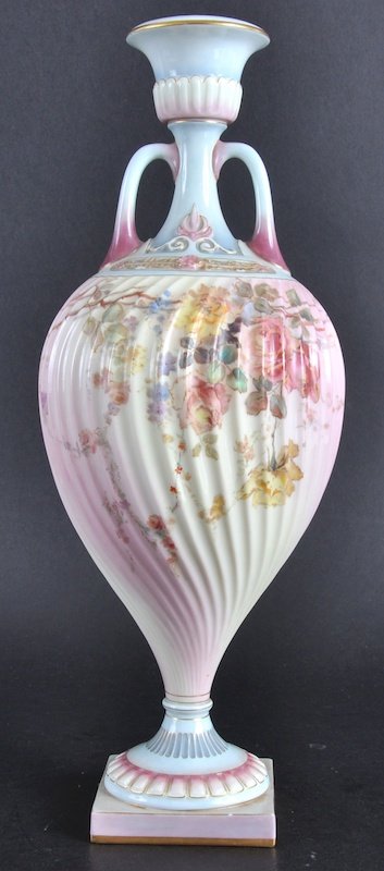 A ROYAL WORCESTER TWO HANDLED SPIRAL VASE, 13. 5i: A ROYAL WORCESTER TWO HANDLED SPIRAL VASE, 13. 5ins high, faceted moulded vase painted with flowers in prismatic enamels, Circa 1895, Shaped No. 1757.