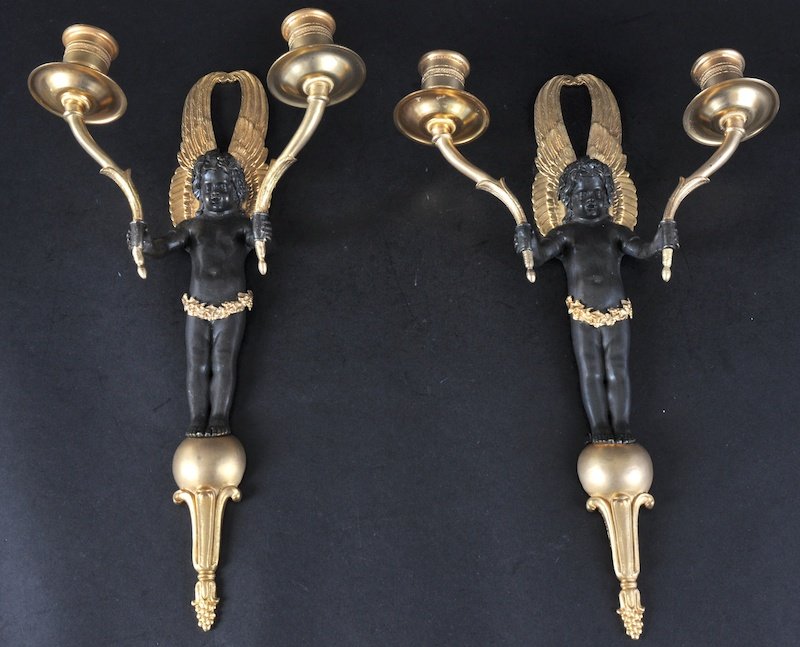 A PAIR OF BRONZE AND ORMOLU NEO CLASSICAL WALL SC: A PAIR OF BRONZE AND ORMOLU NEO CLASSICAL WALL SCONCES in the form of cherubs. 13ins high.