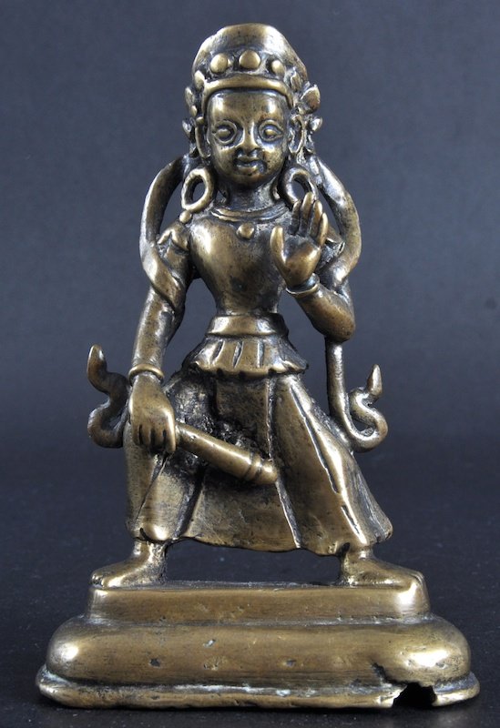 A 16TH/17TH CENTURY INDIAN BRONZE FIGURE OF A FEMA: A 16TH/17TH CENTURY INDIAN BRONZE FIGURE OF A FEMALE modelled holding a baton in one hand, upon a rectangular base. 5. 25ins high.