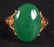 69: A CHINESE YELLOW GOLD AND GREEN APPLE JADE RING. Si