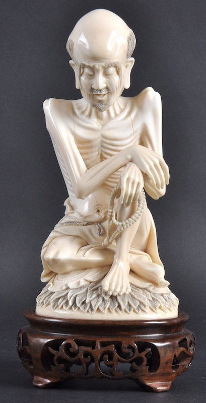 A LOVELY 19TH CENTURY CHINESE CARVED IVORY FIGURE: A LOVELY 19TH CENTURY CHINESE CARVED IVORY FIGURE OF A BUDDHA bearing Qianlong marks to base, upon a lotus base. Natural splits. 6. 75ins high.