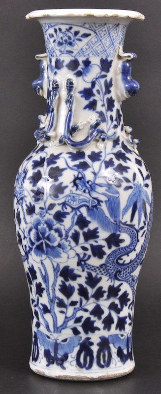 AN EARLY 19TH CENTURY CHINESE BLUE AND WHITE VASE: AN EARLY 19TH CENTURY CHINESE BLUE AND WHITE VASE bearing Kangxi marks to base, painted with dragons amongst foliage. Minor fritting. 12ins high.