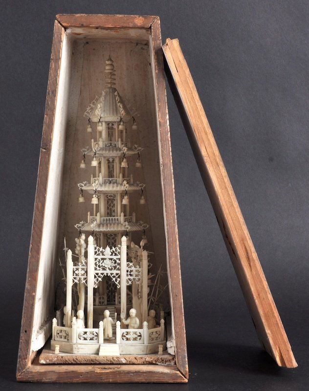 A 19TH/20TH CENTURY CHINESE CARVED IVORY TEMPLE d: A 19TH/20TH CENTURY CHINESE CARVED IVORY TEMPLE decorated with figures standing beside a temple, with hanging bells and sprouting foliage. Few faults. 10. 5ins high.