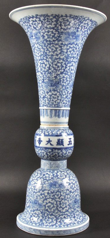 A 19TH CENTURY CHINESE BLUE AND WHITE ‘GU’ PORCEL: A 19TH CENTURY CHINESE BLUE AND WHITE ‘GU’ PORCELAIN VASE Daoguang, painted with fine foliate scrolls and floral roundels. Firing flaw to body. 1ft 10ins high.
