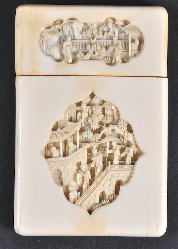 A 19TH CENTURY CHINESE CANTON IVORY CARD CASE AND : A 19TH CENTURY CHINESE CANTON IVORY CARD CASE AND COVER carved with panels of figures within landscapes. Minor natural flaws.4.5ins x 3ins.