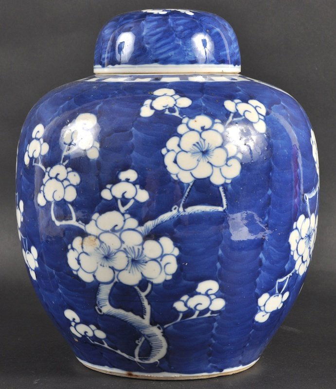 A 19TH CENTURY CHINESE BLUE AND WHITE GINGER JAR A: A 19TH CENTURY CHINESE BLUE AND WHITE GINGER JAR AND COVER painted with prunus. Good condition. 10ins high.