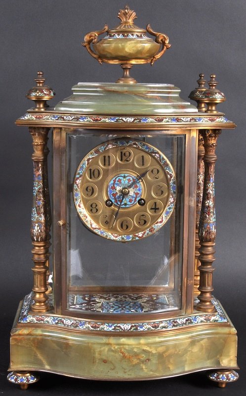 A VERY LARGE 19TH CENTURY FRENCH GREEN ONYX AND C: A VERY LARGE 19TH CENTURY FRENCH GREEN ONYX AND CHAMPLEVE ENAMEL PILLAR SUPPORTED CLOCK with circular dial and serpentine front with urn finials. 18ins high.