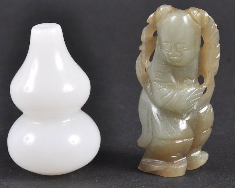 AN EARLY 20TH CENTURY CHINESE GREEN JADE CARVED FI: AN EARLY 20TH CENTURY CHINESE GREEN JADE CARVED FIGURE OF A BOY together with a white jade double gourd. Natural fissures. (2)