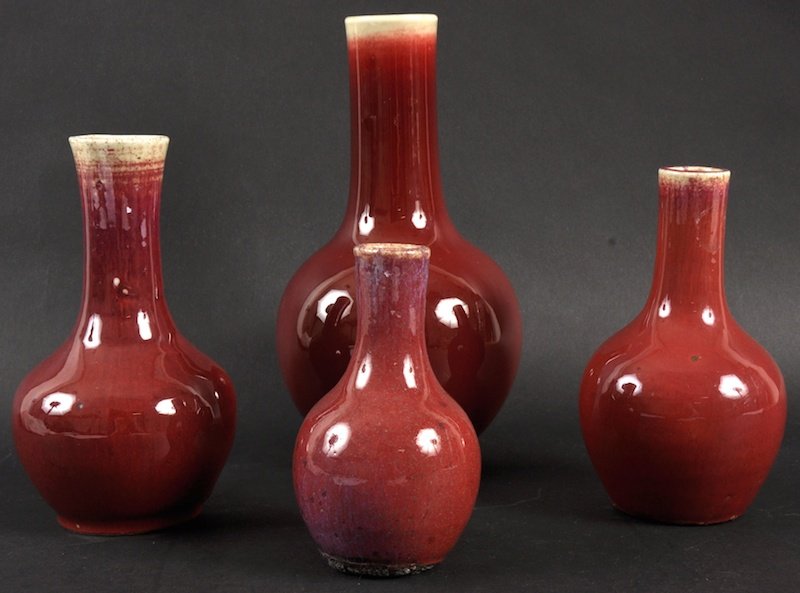 A 19TH CENTURY CHINESE FLAMBE GLAZED BULBOUS VASE : A 19TH CENTURY CHINESE FLAMBE GLAZED BULBOUS VASE together with three other sang du boeuf type vases. Minor fritting. Largest 7. 75ins high. (4)