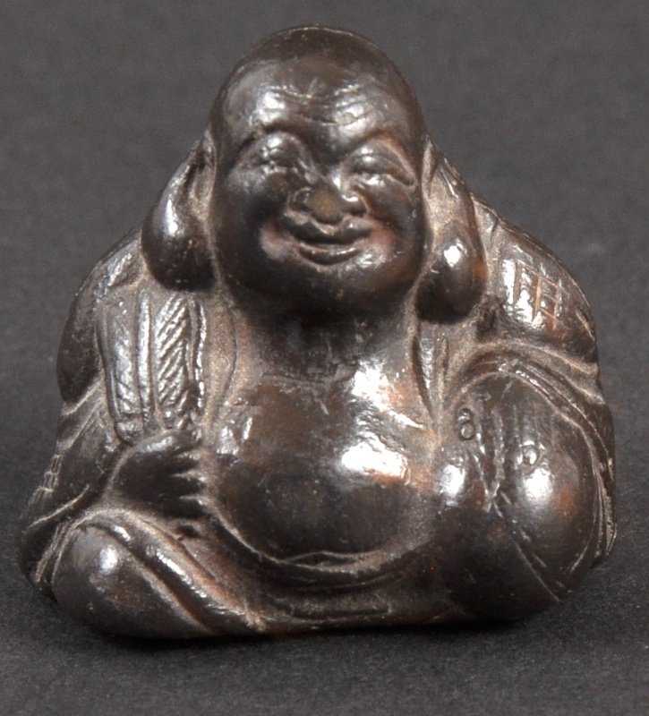 A CARVED IVORY NETSUKE OF A BUDDHA. : A CARVED IVORY NETSUKE OF A BUDDHA.