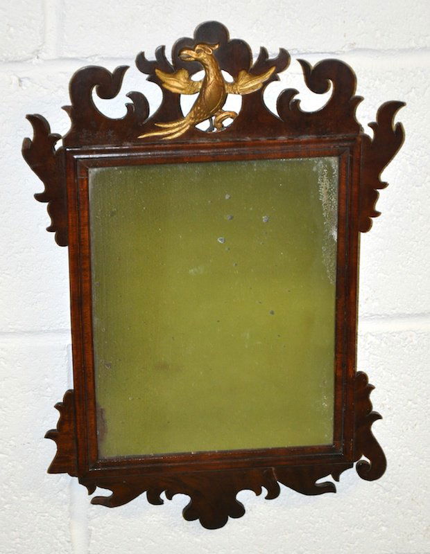 A SMALL GEORGE III MAHOGANY FRETWORK FRAMED WALL: A SMALL GEORGE III MAHOGANY FRETWORK FRAMED WALL MIRROR with ho-ho bird cresting. 1ft 6ins high x 1ft 0ins wide.