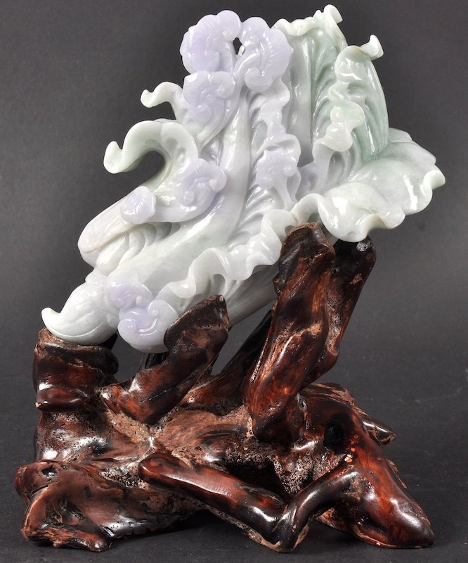 AN EARLY 20TH CENTURY CHINESE CARVED LAVENDER JADEI: AN EARLY 20TH CENTURY CHINESE CARVED LAVENDER JADEITE FLORAL SPRIG upon a carved rootwood base. Good condition. Jade 4.75ins x 4.25ins.