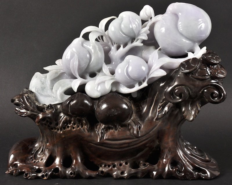 AN EARLY 20TH CENTURY CHINESE LAVENDER JADEITE CARV: AN EARLY 20TH CENTURY CHINESE LAVENDER JADEITE CARVED FRUIT of naturalistic form upon a root base. Few natural fissures. Jade 8.5ins x 4ins.
