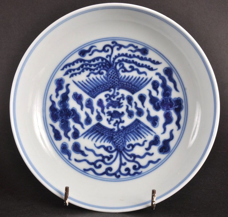 A CHINESE BLUE AND WHITE CIRCULAR DISH Daoguang ma: A CHINESE BLUE AND WHITE CIRCULAR DISH Daoguang mark and probably of the period, painted with dragons and phoenix birds in flight. Glaze flaw to rim. 6.5ins diameter.