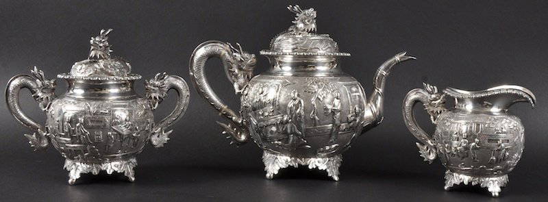 A FINE LATE 19TH CENTURY CHINESE EXPORT SILVER TE: A FINE LATE 19TH CENTURY CHINESE EXPORT SILVER TEASET BY WANG HING exceptionally modelled with dragon handles and finials, the bodies decorated with figures in buildings and landscapes. Good condition