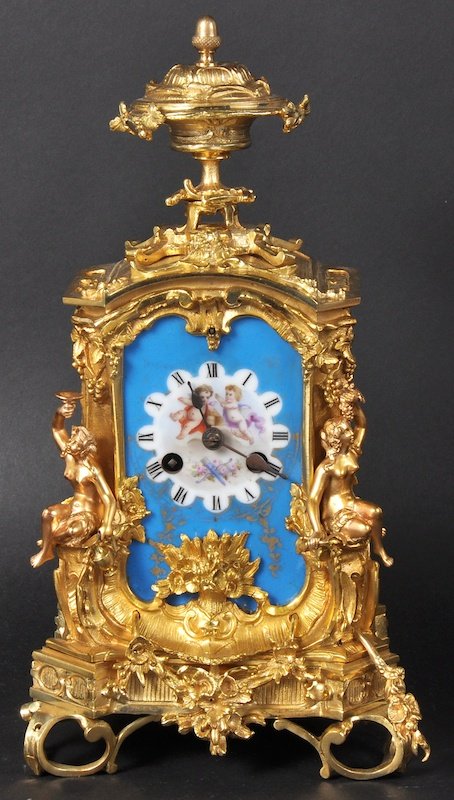 A VERY GOOD 19TH CENTURY FRENCH ORMOLU AND SEVRES MANT: A VERY GOOD 19TH CENTURY FRENCH ORMOLU AND SEVRES MANTLE CLOCK by HERSANT, PARIS, fitted with three superb blue Sevres porcelain plaques surmounted by an urn finial. 12ins high.