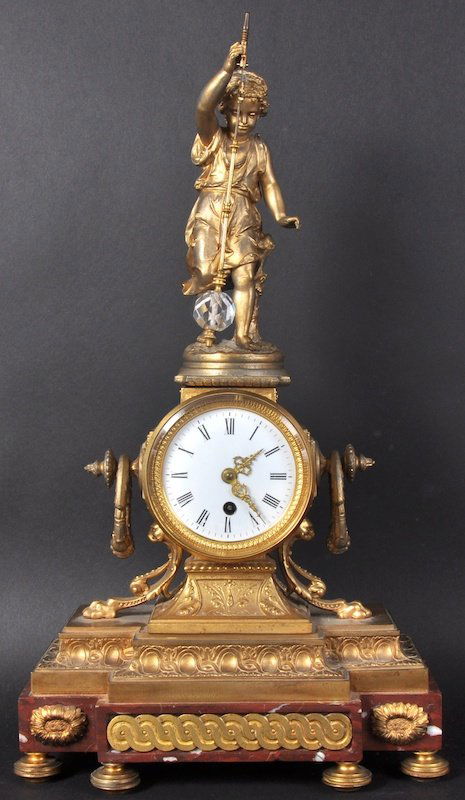 A GOOD 19TH CENTURY FRENCH ORMOLU AND MARBLE MYSTERY C: A GOOD 19TH CENTURY FRENCH ORMOLU AND MARBLE MYSTERY CLOCK, the top with a figure holding a cut glass pendulum, circular white dial, claw feet and mounted base. 21ins high.