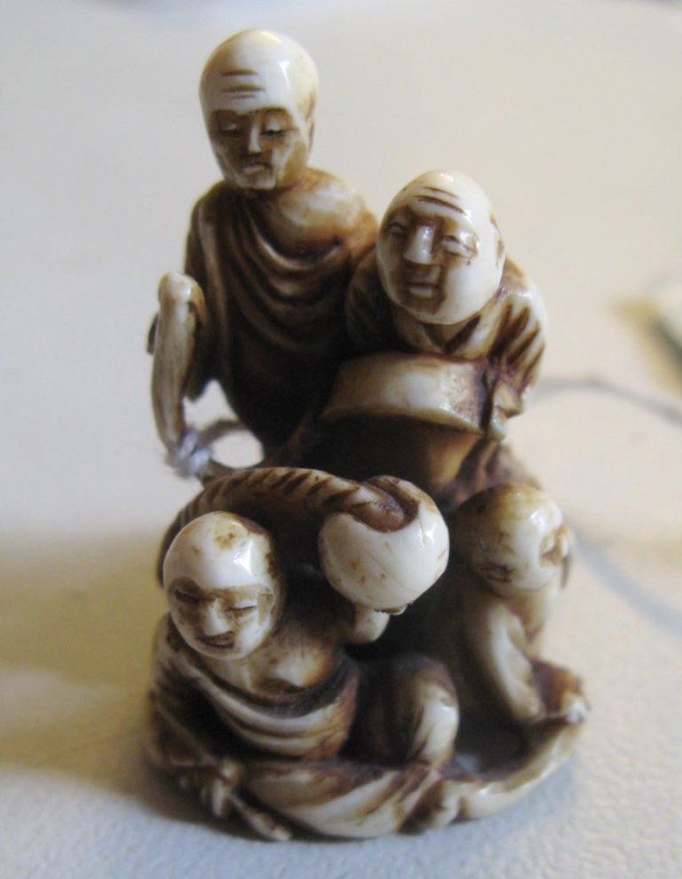 Japan, ivory netsuke of group of 4 dragon-catchers, 1.7: Japan, ivory netsuke of group of 4 dragon-catchers, 1.7” high, dragon coiled around 4 catchers, superb