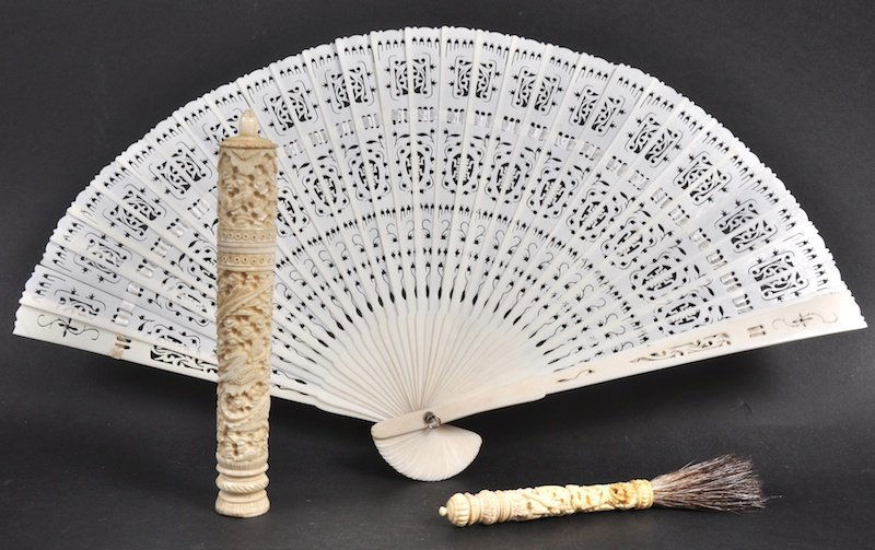 A 19TH CENTURY CHINESE CANTON IVORY NEEDLE CASE AND COV: A 19TH CENTURY CHINESE CANTON IVORY NEEDLE CASE AND COVER together with a brush and fan. Minor faults. (3)