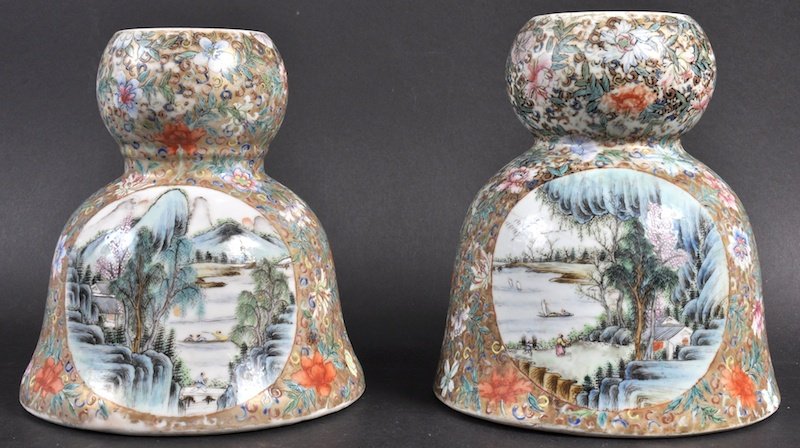 A NEAR PAIR OF CHINESE QING DYNASTY PORCELAIN INCENSE B: A NEAR PAIR OF CHINESE QING DYNASTY PORCELAIN INCENSE BURNERS bearing Qianlong marks to base, enamelled with landscapes. One cracked, minor wear. 6.75ins & 6.5ins high.