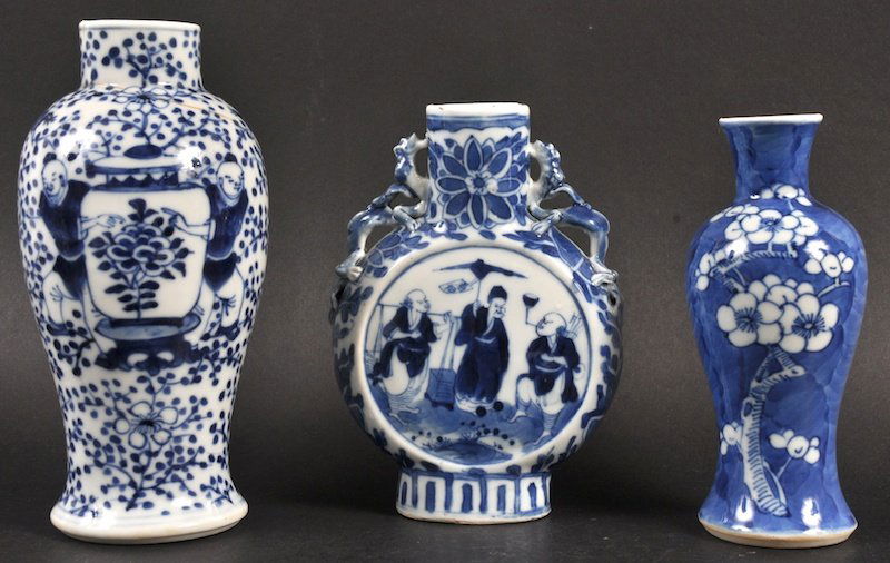 A 19TH CENTURY CHINESE BLUE AND WHITE MOON FLASK painte: A 19TH CENTURY CHINESE BLUE AND WHITE MOON FLASK painted with figures within a central panel, together with two other vases. Some faults. Largest 5.75ins high. (3)