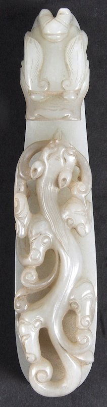 A GOOD 18TH CENTURY CHINESE WHITE JADE CARVED BELT HOOK: A GOOD 18TH CENTURY CHINESE WHITE JADE CARVED BELT HOOK Qianlong, with finely carved features, modelled with a roaming dragon the main body. Good condition. 5.25ins long.