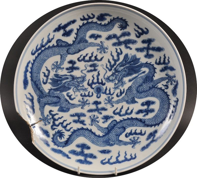A CHINESE BLUE AND WHITE CIRCULAR PORCELAIN CHARGER Gua: A CHINESE BLUE AND WHITE CIRCULAR PORCELAIN CHARGER Guangxu mark and probably of the period, painted with five claw dragon. Chip and firing crack. 13.5ins diameter.