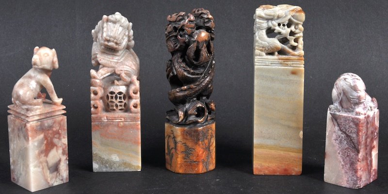 A GROUP OF FIVE EARLY 20TH CENTURY CHINESE CARVED SOAPS: A GROUP OF FIVE EARLY 20TH CENTURY CHINESE CARVED SOAPSTONE SEALS in various form. Largest 5ins high. (5)