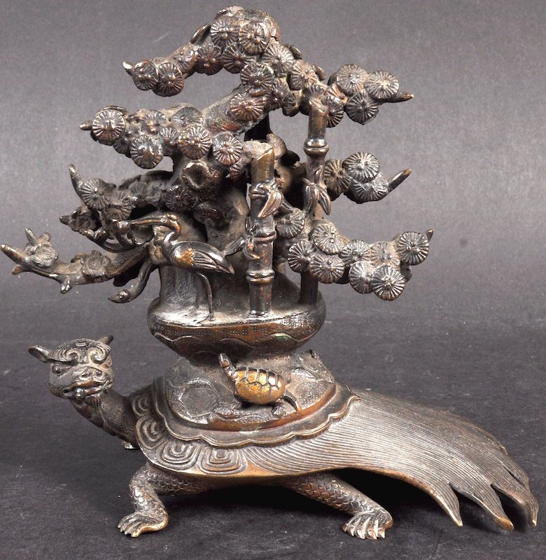 A 19TH CENTURY CHINESE BRONZE FIGURE OF A TORTOISE mode: A 19TH CENTURY CHINESE BRONZE FIGURE OF A TORTOISE modelled with a flowering pine tree upon his back. Minor wear. 5.5ins high.