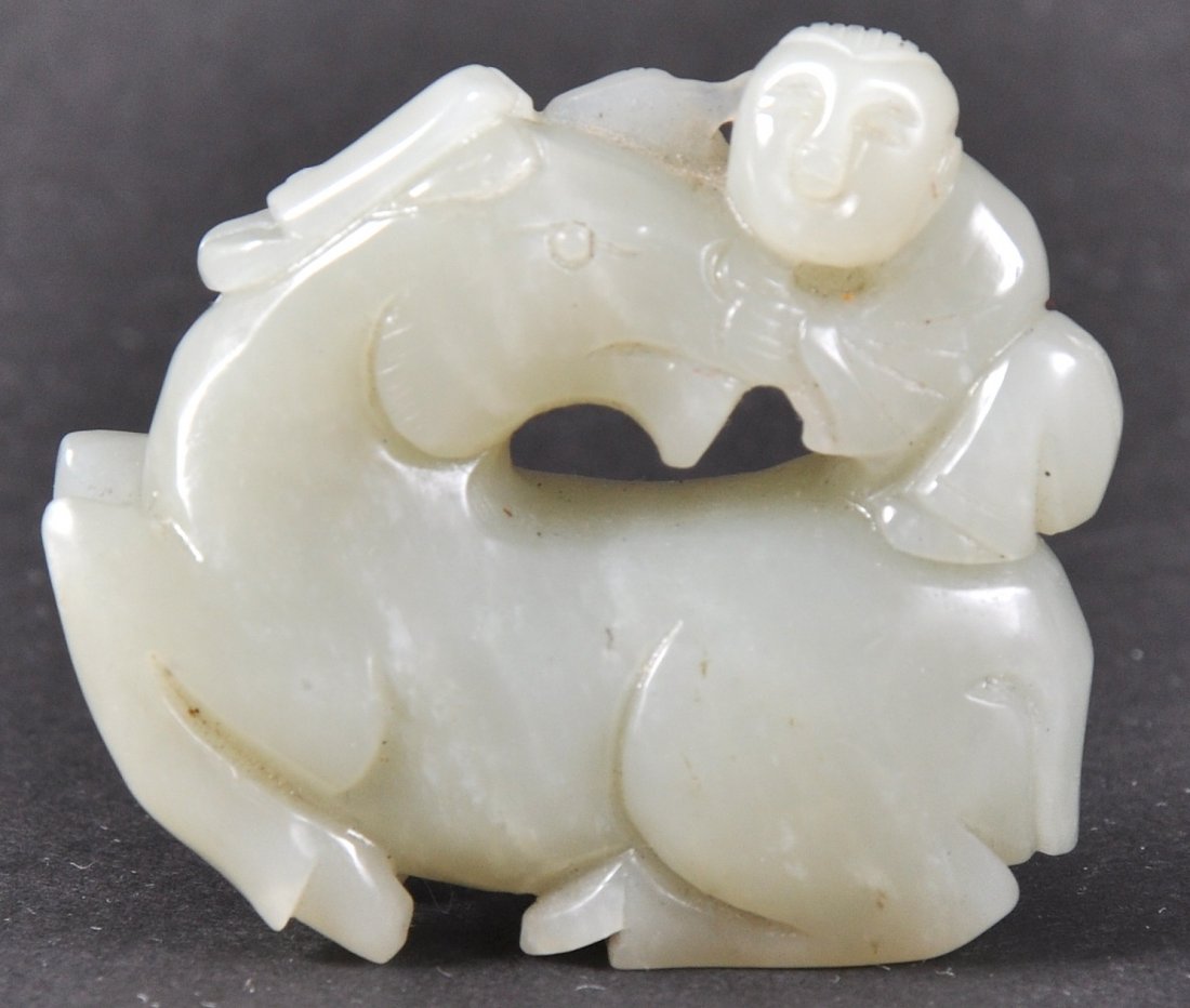 A GOOD CHINESE QING DYNASTY GREEN JADE CARVED HORSE: modelled with a young child upon its back. 2ins wide. Good condition.