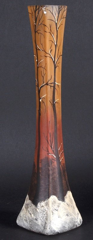 A TALL SLENDER “DAUM” NANCY SPILL VASE painted with tre: A TALL SLENDER “DAUM” NANCY SPILL VASE painted with trees. Signed. 12ins high.