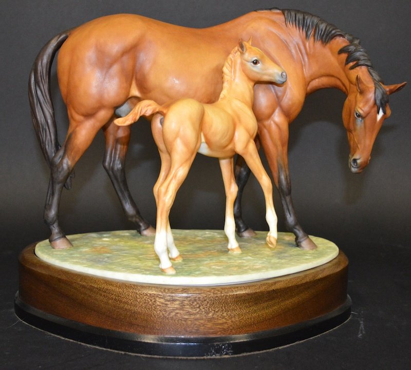 A ROYAL WORCESTER PORCELAIN GROUP, “PRINCE’S GRACE & F: A ROYAL WORCESTER PORCELAIN GROUP, “PRINCE’S GRACE & FOAL” by DORIS LINDNER.8.5ins high. No.445. Complete with original wooden stand.