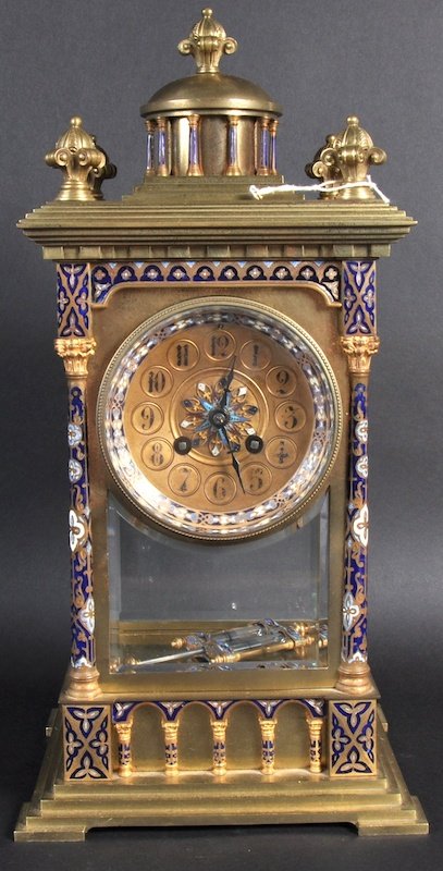 A GOOD 19TH CENTURY FRENCH CHAMPLEVE ENAMEL GOTHIC STYL: A GOOD 19TH CENTURY FRENCH CHAMPLEVE ENAMEL GOTHIC STYLE CLOCK by A. HOUGIN striking on a gong with column supports. 17ins high.