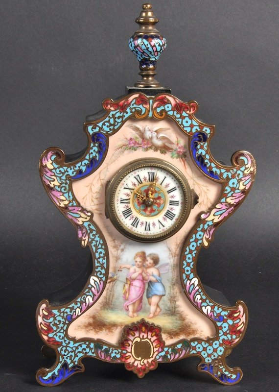 A 19TH CENTURY FRENCH ORMOLU MANTLE CLOCK with chample: A 19TH CENTURY FRENCH ORMOLU MANTLE CLOCK with champlevé enamel and a porcelain panel painted with cupids, doves and garlands. 10ins high.