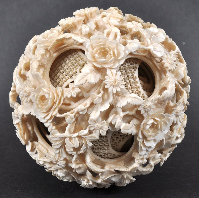 A FINE 19TH CENTURY CHINESE CARVED CANTON IVORY PUZZLE : A FINE 19TH CENTURY CHINESE CARVED CANTON IVORY PUZZLE BALL carved unusually with foliage and floral roundels and vines. Appears in good condition.375ins diameter.
