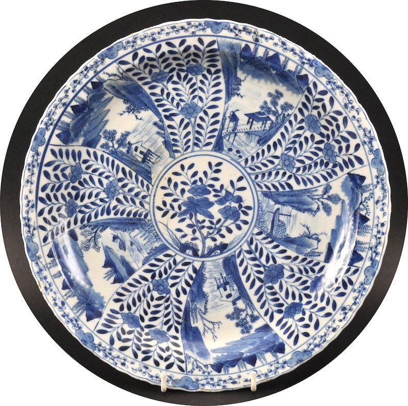 A 19TH CENTURY CHINESE BLUE AND WHITE SCALLOPED PLATE : A 19TH CENTURY CHINESE BLUE AND WHITE SCALLOPED PLATE bearing Xuande marks to base, painted with landscapes. Minor nicks.1175ins diameter.