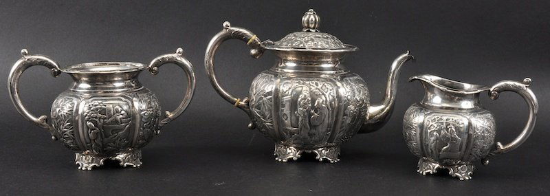 A FINE LATE 19TH CENTURY CHINESE SILVER EXPORT THREE P: A FINE LATE 19TH CENTURY CHINESE SILVER EXPORT THREE PIECE TEA SET BY HUNG CHONG Shanghai, decorated with panels of figures and birds. Good condition. Teapot 8.5ins wide. (3)