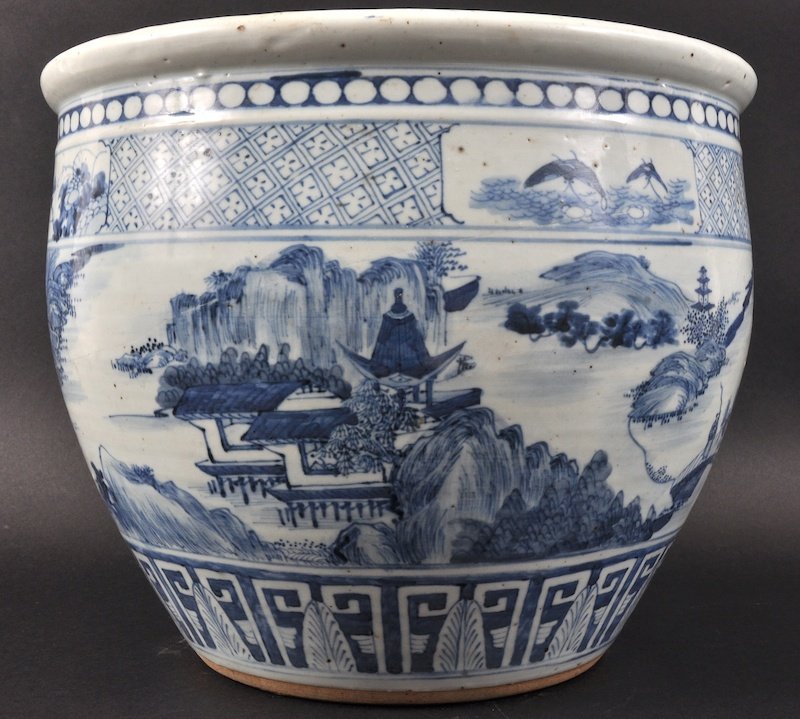 A 19TH CENTURY CHINESE BLUE AND WHITE LANDSCAPE PLANTER: A 19TH CENTURY CHINESE BLUE AND WHITE LANDSCAPE PLANTER painted with figures standing upon a bridge. A/F.1175ins diameter.