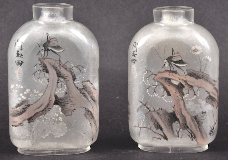 MANNER OF ZHOU LEYUAN (CHINESE) 19TH CENTURY A PAIR OF : MANNER OF ZHOU LEYUAN (CHINESE) 19TH CENTURY A PAIR OF REVERSE PAINTED CRYSTAL SNUFF BOTTLES both decorated with landscapes and insects.25ins high.