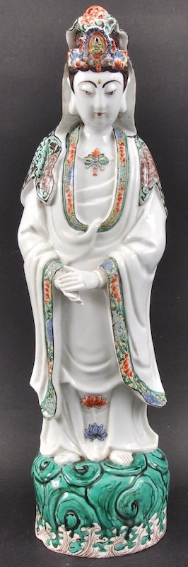 A CHINESE QING DYNASTY FAMILLE VERTE PORCELAIN FIGURE : A CHINESE QING DYNASTY FAMILLE VERTE PORCELAIN FIGURE OF GUANYIN modelled upon a green glazed base. Fingers restored, short hairline to base. 1ft 4.5ins high.