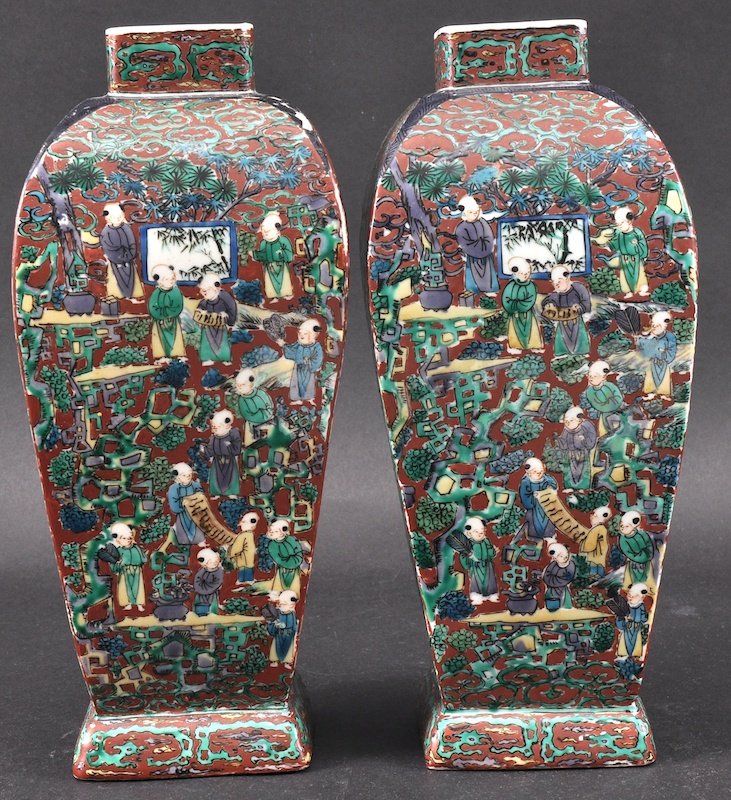 A PAIR OF JAPANESE EDO PERIOD ARITA PORCELAIN VASES pr: A PAIR OF JAPANESE EDO PERIOD ARITA PORCELAIN VASES probably 18th century, enamelled with figures within a busy landscape. Minor fritting.1125ins high.