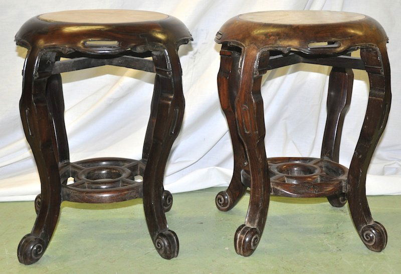 A PAIR OF LATE 19TH CENTURY CHINESE CARVED HARDWOOD TAB: A PAIR OF LATE 19TH CENTURY CHINESE CARVED HARDWOOD TABLES inset with white marble plaques. 1ft 6ins high x 1ft 1ins diameter.