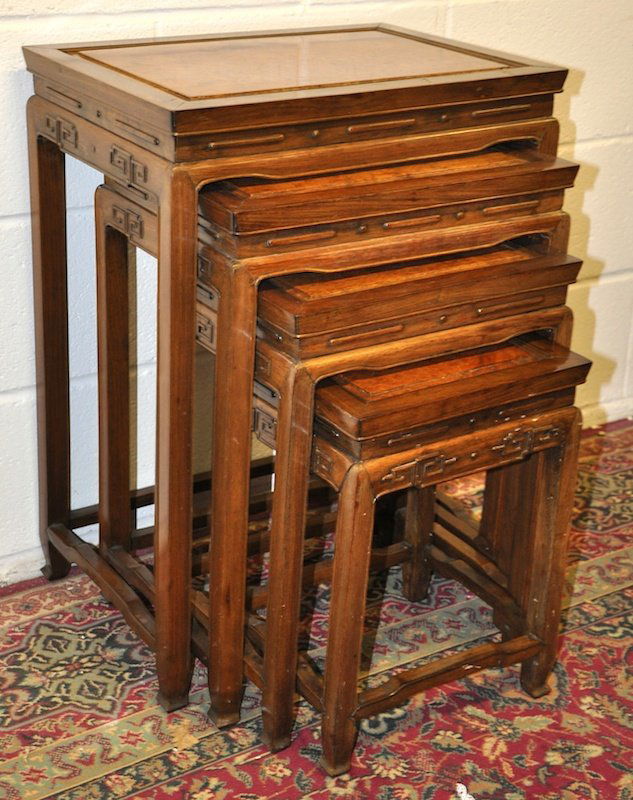 A NEST OF FOUR CHINESE HUANGHUALI WOOD TABLES, circa 19: A NEST OF FOUR CHINESE HUANGHUALI WOOD TABLES, circa 1900, with figured panelled tops, simply carved frieze on square legs. Largest 1ft 8ins wide x 1ft 2ins deep x 2ft 3.5ins high.