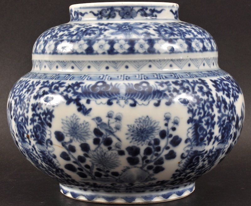 AN UNUSUAL 19TH CENTURY CHINESE BLUE AND WHITE GLOBULAR: AN UNUSUAL 19TH CENTURY CHINESE BLUE AND WHITE GLOBULAR VASE bearing Kangxi marks to base, painted with birds amongst foliage. Rim repair, hairline. 7ins diameter.