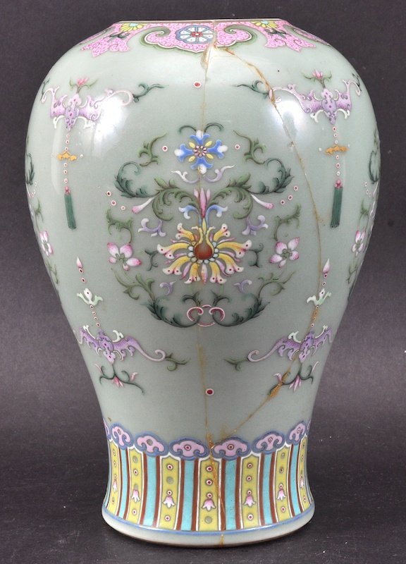 A 19TH CENTURY CHINESE GREEN CELADON ENAMELLED VASE Dao: A 19TH CENTURY CHINESE GREEN CELADON ENAMELLED VASE Daoguang, bearing Qianlong marks to base, painted with flowers. Repaired, reduced neck. 7.5ins high.