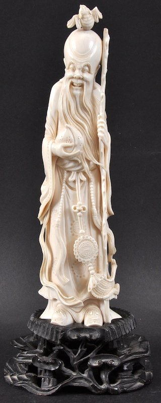 A LOVELY 19TH CENTURY CHINESE IVORY FIGURE OF SAGE mode: A LOVELY 19TH CENTURY CHINESE IVORY FIGURE OF SAGE modelled holding a staff and peach, upon a fitted hardwood stand. Good condition. Ivory 9.75ins high.