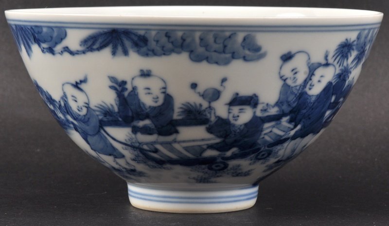 A CHINESE BLUE AND WHITE CIRCULAR FLARED BOWL bearing Y: A CHINESE BLUE AND WHITE CIRCULAR FLARED BOWL bearing Yongzheng marks to base, painted with children within a landscape. Crazing. 5.25ins diameter.